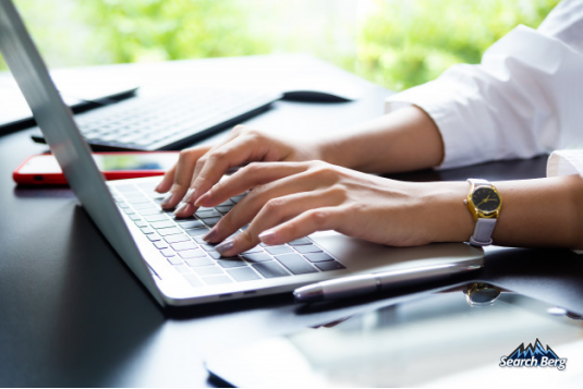 an individual working on long-form content on a laptop