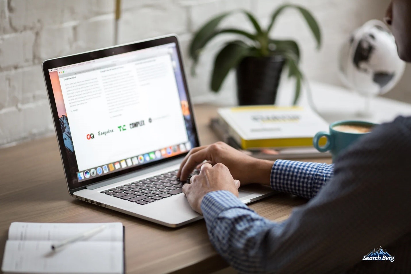 man creating content on his laptop in a professional setting