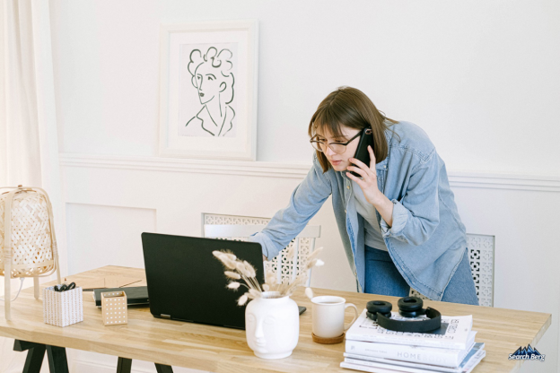 an individual creating content on their laptop in a home office